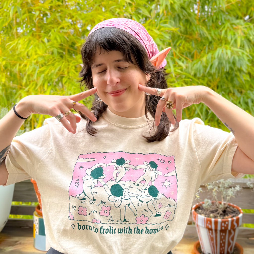 Person wearing a t-shirt with a graphic design and text, outdoors.